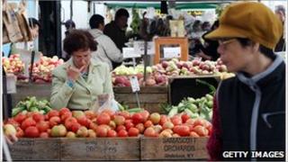Picture of a man at a fruit stall in a New York farmers market