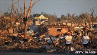 Joggers pass homes destroyed in Sunday's tornado
