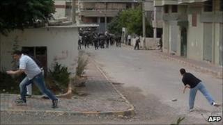 Unverified image appearing to show men throwing stones at security forces in Baniyas, Syria