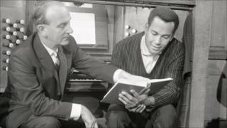 Organist Arwel Hughes and singer Cy Grant in a Songs of Praise rehearsal in 1961