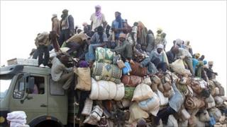 Ghanaian and Nigerian migrants fleeing Libya arrive in Agadez, Niger, on a truck - May 2011