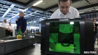Airport staff in Germany demonstrate a new liquid scanner