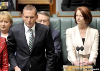 Australian Prime Minister Julia Gillard (right) listens as opposition leader Tony Abbott (left) is sworn in at the House of Representatives, Canberra, 28 September 2010