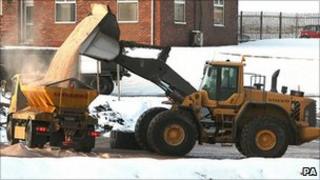 A digger fills a truck with rock salt at Winsford Rock Salt Mine