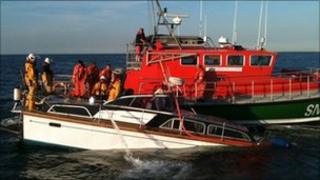 Sinking motorboat alongside lifeboat (Picture by Nicola Thomas)