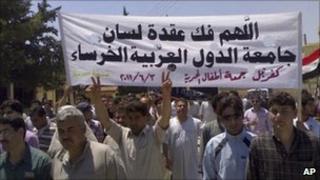 Mobile phone photo of a protest in the northern Syrian town of Idlib. Banner reads: "May God help break the silence of the Arab League" (3 June 2011)
