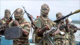Masked gunmen on a boat in Nigeria