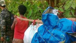 Local people carry the bodies