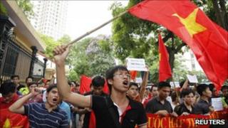 Anti-China protesters wave the Vietnamese national flag during a demonstration in Hanoi (12 June)
