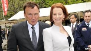 Australian Prime Minister Julia Gillard (R) and her partner Tim Mathieson stroll open air shops in Tokyo on April 22, 2011