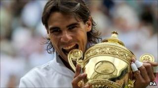 Rafael Nadal celebrates with the Wimbledon trophy after winning the title in 2010