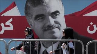 Women pass by a giant portrait of former Lebanese Prime Minister Rafik Hariri near his grave, Beirut, Lebanon, 30 June 2011