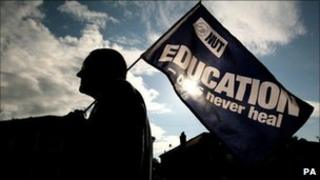 A teacher on a picket line outside Stretford High School in Manchester