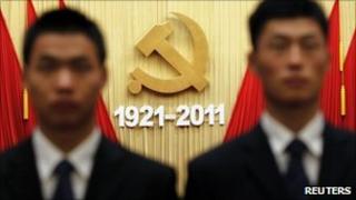 Security officers stand guard after the celebration of the 90th anniversary of the founding of Communist Party of China (CPC), at the Great Hall of the People in Beijing July 1, 2011