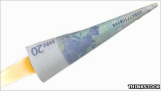 A Euro note rolled into a cone and made to look like a rocket blasting off.