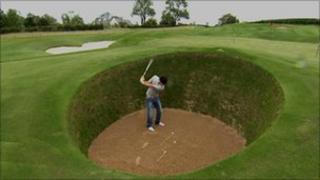 Rory McIlroy in his replica of the infamous Road Hole Bunker at St Andrews