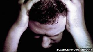 Man holding his head in his hands