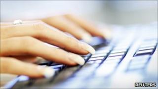 A woman uses a computer keyboard (file photo)