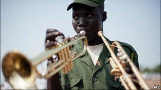 A South Sudanese soldier plays the trumpet during a parade rehearsal in Juba on 7 July 2011