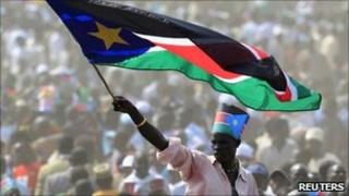 A man waves South Sudan's national flag as he attends the independence day celebrations in the capital Juba, 9 July 2011