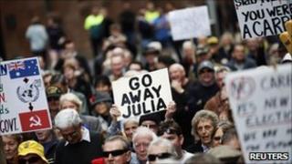 Protesters hold a banner against Australian Prime Minister Julia Gillard during a rally against a carbon tax in central Sydney July 1, 2011