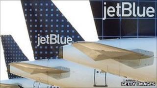 The tails of three JetBlue planes
