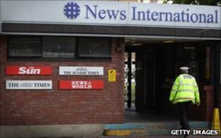 Policeman walking into News International offices