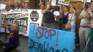 The flashmob protesters with signs that read "Stop evictions!"