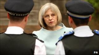 Home Secretary Theresa May talks to police officers