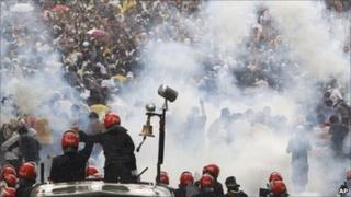 Malaysian riot police officers fire tear gas at activists from Coalition for Clean and Fair Elections (Bersih) during a rally in Kuala Lumpur, Malaysia, Saturday 9 July