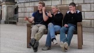 People sitting on the talking bench at Stourhead