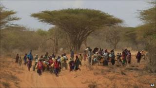 Somalis walk down the main road leading to the refugee camps around Dadaab, Kenya (13 July 2011)