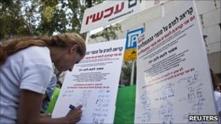 Woman signing petition.