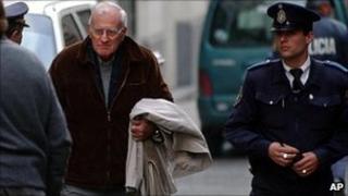 File photo of former Uruguayan President Juan Maria Bordaberry, centre left, leaving a courthouse in Montevideo, Uruguay