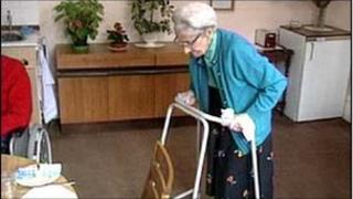 Elderly woman uses walking aid