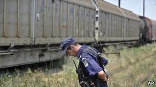 Police guard the freight train. 18 July 2011