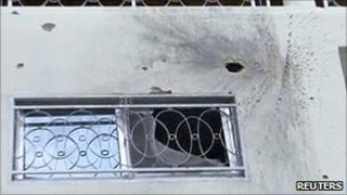 Rocket and bullet marks are seen on a wall of Guinea's President Alpha Conde's residence in Conakry this still image taken from video 19 July 2011