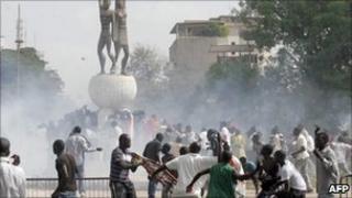 Demonstrators clash with Riot policemen next to Senegal's parliament building in Dakar on 23 June 2011