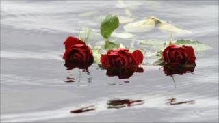 Red roses float in the water close to Utoeya island near Oslo, Norway, 26 July 2011