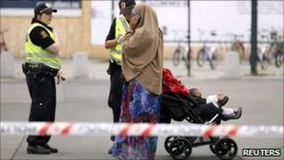 Norwegian police take the details of a Muslim woman near the Oslo train station after a bomb scare - 27 July 2011
