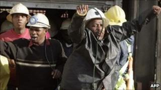 South African miners are seen as they come out from a lift after being stuck for hours in the Elandsrand gold mine, 2007