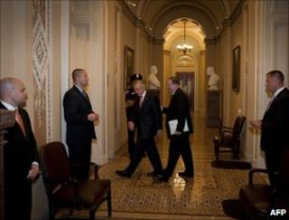 Senator Harry Reid (left) walks back to his office from the Senate chamber, 30 July