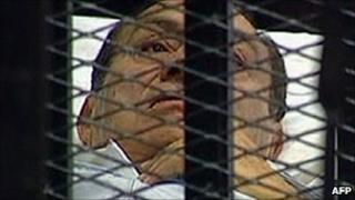 Hosni Mubarak is brought into court in Cairo in this image from state TV