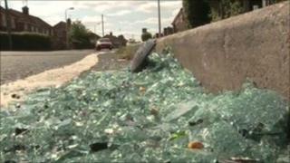 A close up of glass shattered in the kerb after cars were damaged in Whitley