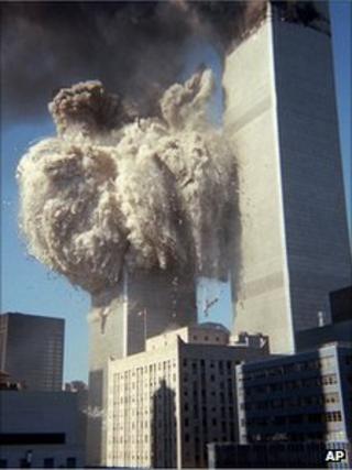 twin towers burns in the background