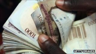 Someone counting Nigerian naira notes