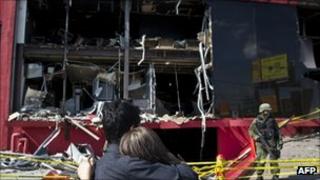 relatives of victims cry in front of the Casino Royale, in Monterrey, Mexico, on 27 August 2011.