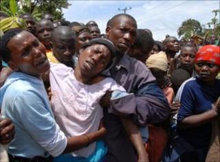 Relatives and friends of the landslide react as they watch rescuers