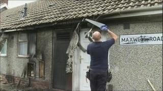 Workman repairing bungalow