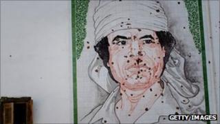 Bullet-ridden mosaic of Col Gaddafi on a wall in Tripoli on 29 August 2011